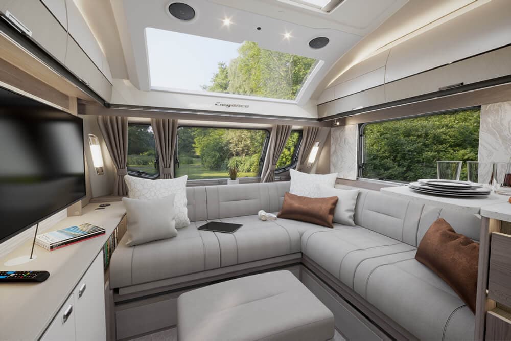 Interior of a Swift Elegance Grande touring caravan showing lounge and kitchen